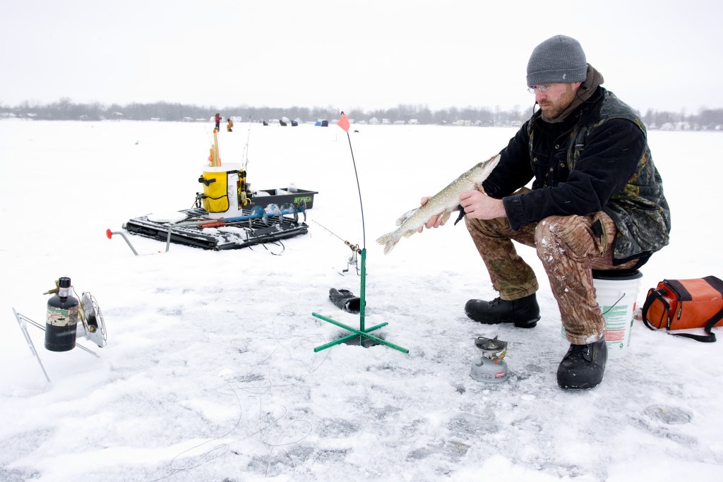 Don't Let those PTO Days Slip Away! Man sitting on a bucket Ice Fishing