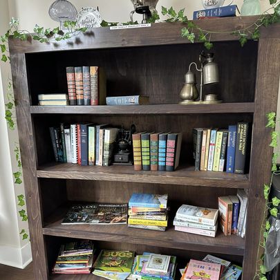 National Book Month and the Stories Connected to Cayuga County’s History Book case filled with books at White Rabbit Roasting Company