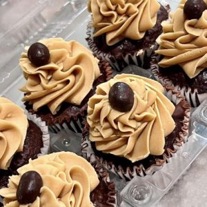 A group of cupcakes with frosting.
