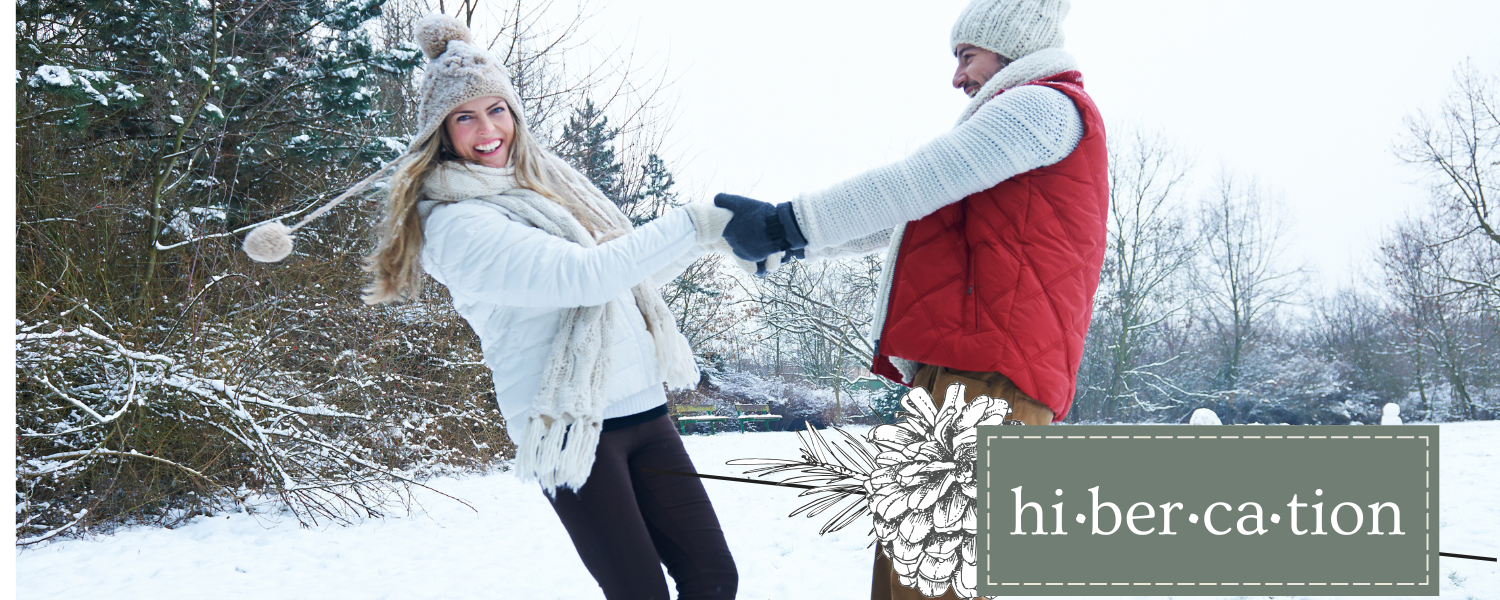 Hibercation-Inspiration woman and man enjoying the winter outside in the snow and enjoying a Hibercation getaway