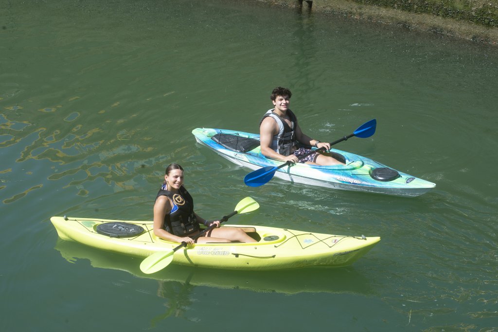 Two people in kayaks on the water