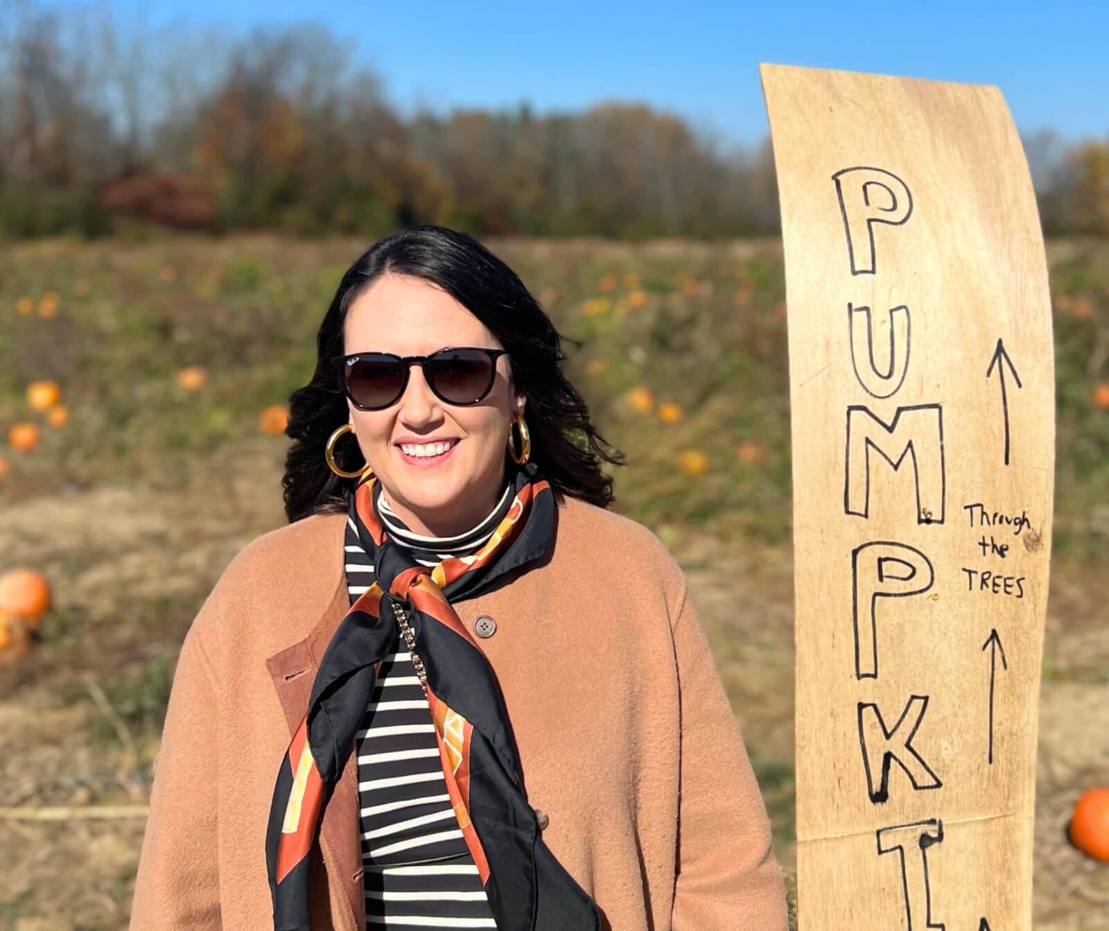 Meet the Tour Cayuga Staff Courtney Kasper standing in a pumpkin patch