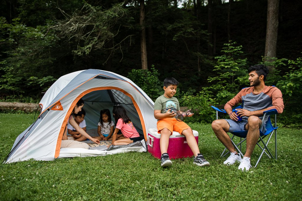 Don't Let those PTO Days Slip Away! small tent on green grass with family of 2 sitting outside on chairs