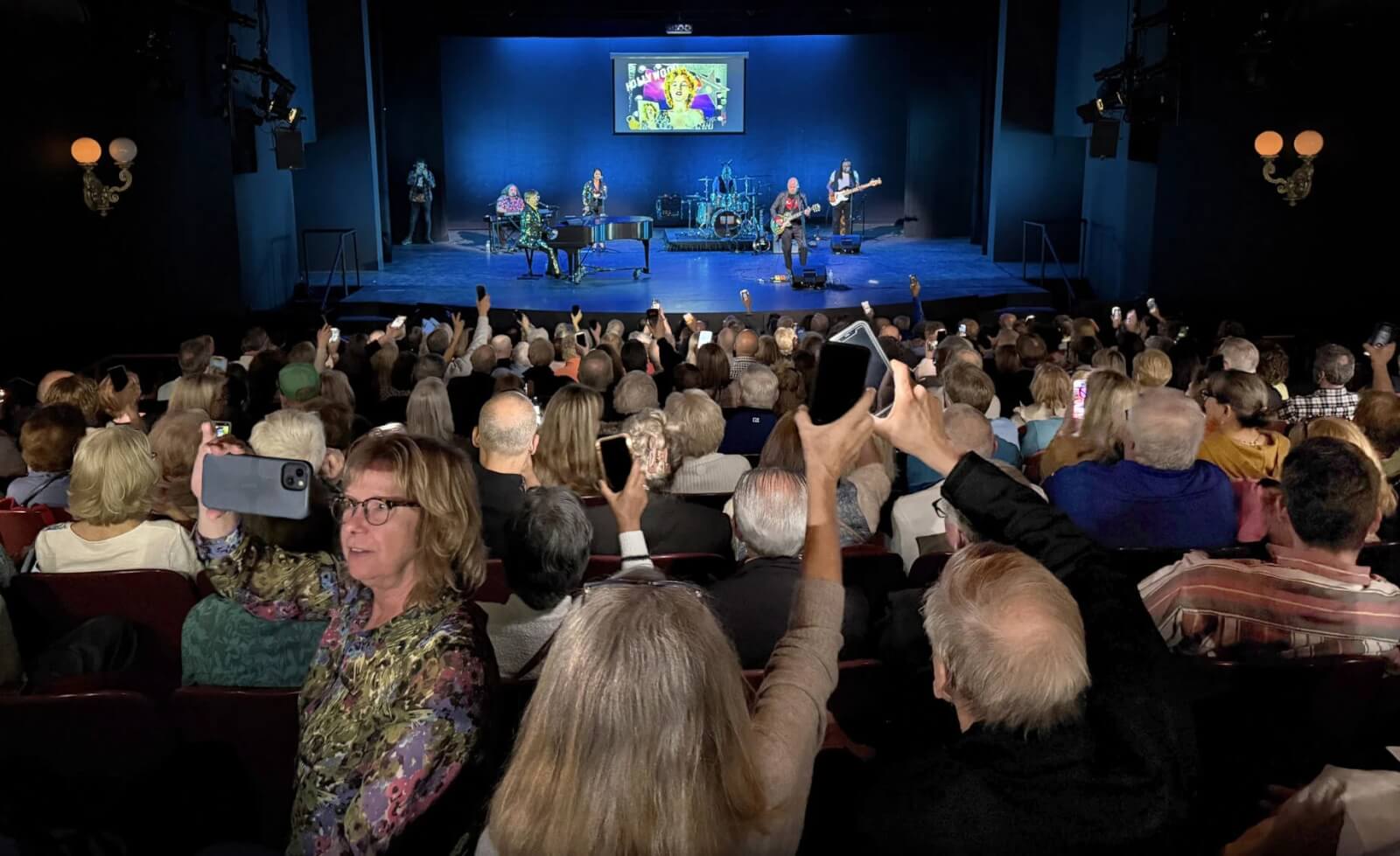 Broadway in the Finger Lakes Returns-2026 Broadway in the Fingerlakes REV Theatre. Interior of the play house filled with patrons enjoying a production of Elton John.