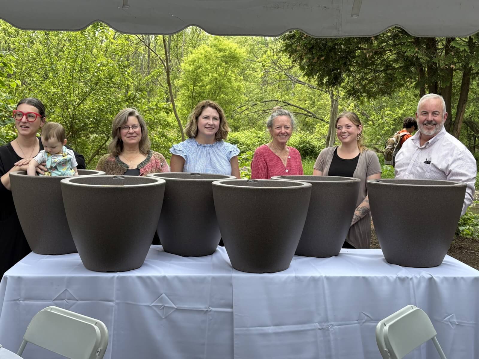 Partners Page Six Tour Cayuga Partners standing in front of of their annual support gift of a large planter
