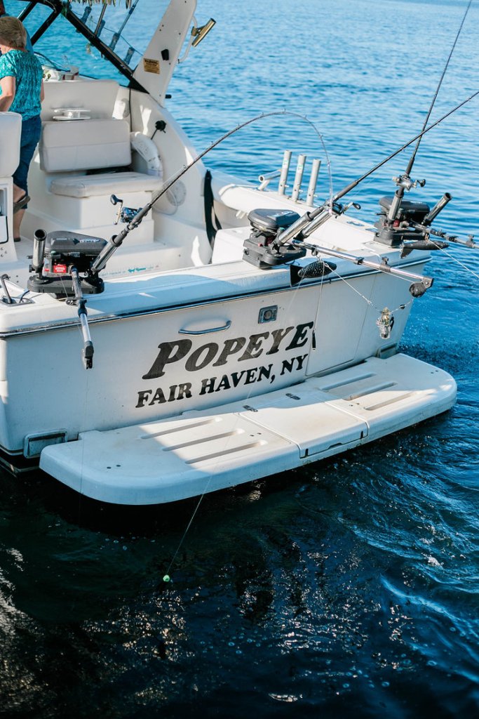 An Unforgettable Fishing Adventure with Popeye Charters fishing boat on the water showing off name or Popeye
