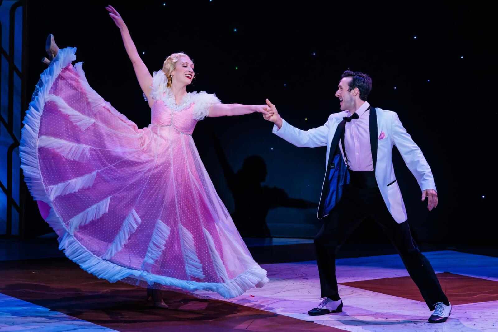 Broadway in the Finger Lakes Returns-2026 Two people ballroom dancing during a performance of the REV Theatre's production of Top Hat at the Merry-go-Round Playhouse.