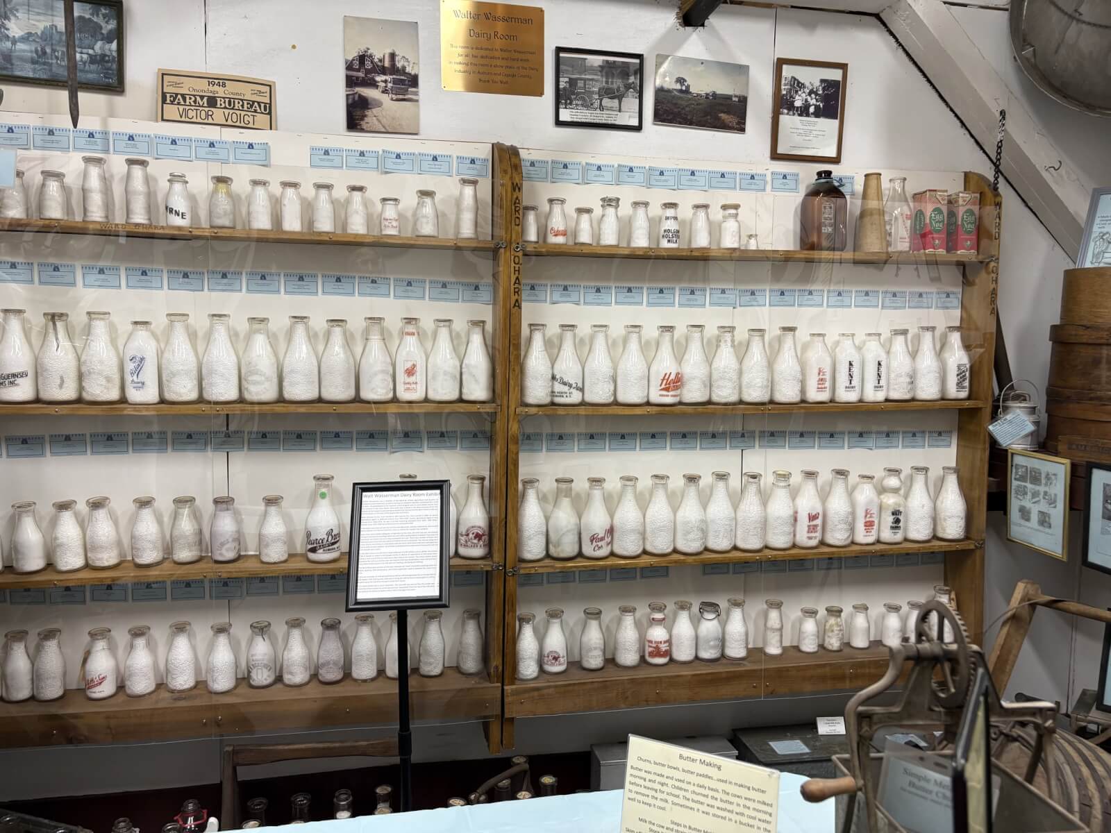 Old fashioned milk bottles lined up on a shelf in celebration of Dairy Month
