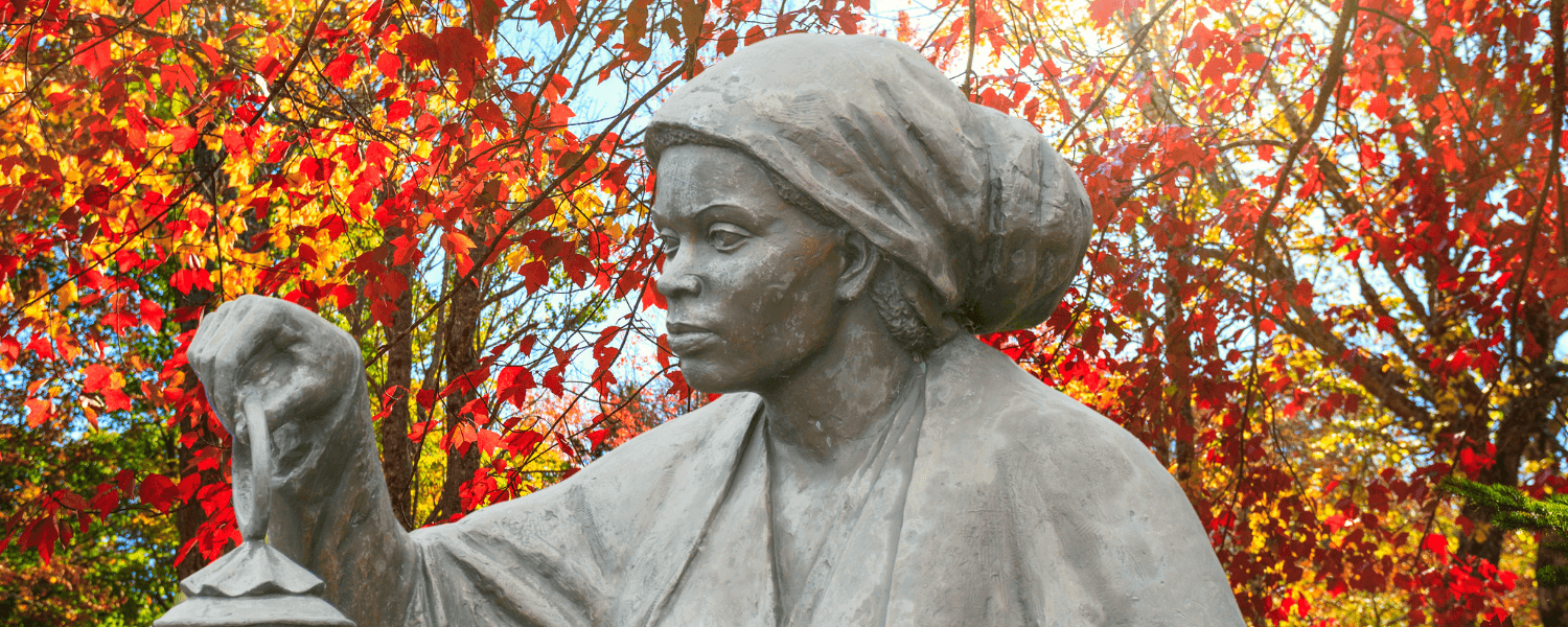 Harriet Tubman Statue in front of fall foliage 