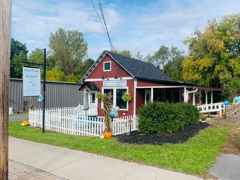 Finger Lakes Sweet Treat Trail -2026 picture of a small red building with a white picket fence around it