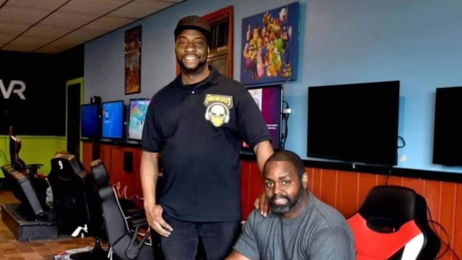 The  two owners of the Hideout in Auburn sitting on chairs inside their gaming space