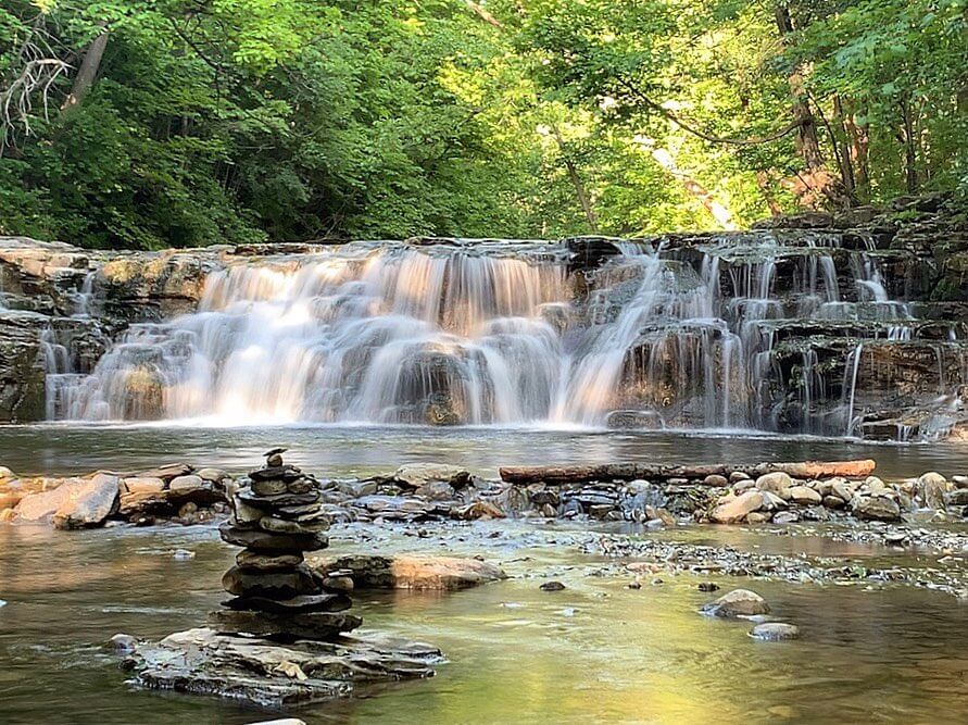 Great Gully wide, stout waterfall. Lush greenery in the background